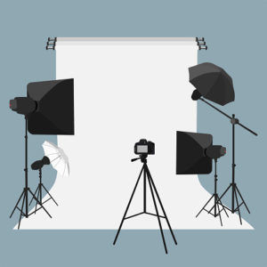 a studio with four lights, a tripod and camera